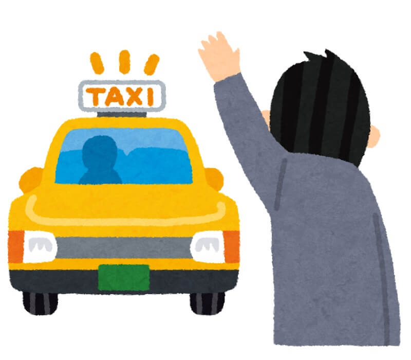 タクシーを止める男性